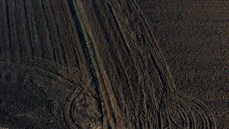 Landscape of plowed up land on an agricultural field on a sunny autumn day. Flying over the plowed...