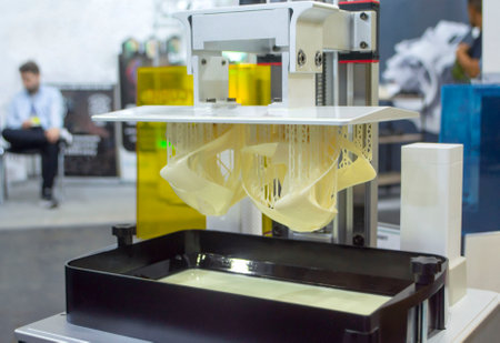 Printed models on 3D printer close-up. Objects printed on photopolymer sla 3D printer from liquid photopolymer resins on printing platform. Modern progressive additive technology. 3D printer printingの写真素材