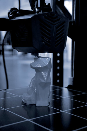 Working 3D printer printing an object from plastic. Printing a model from molten plastic using a 3D printer. Creation of a form by a 3D printer. Additive progressive new modern 3d printer technologyの写真素材