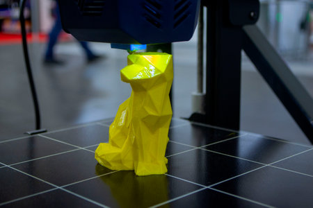 Working 3D printer printing an object from plastic. Printing a model from molten plastic using a 3D printer. Creation of a form by a 3D printer. Additive progressive new modern 3d printer technologyの写真素材