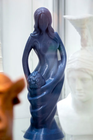 Art object printed on 3D printer. Figure of woman of blue color among other models printed on 3D printer from melted plastic. Object printed close-up. Concept new modern innovation printing technologyの写真素材