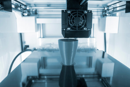 3D printer working close-up. 3D printer prints model from molten plastic close-up. 3D printer...