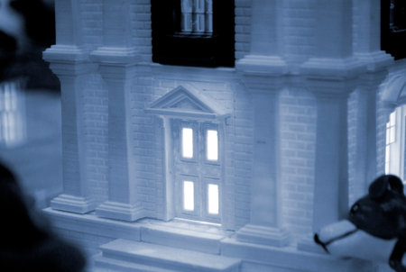 Model of building with white and black color, windows with light shining, created by 3D printer from...