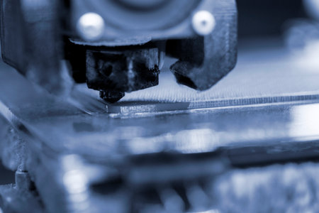 3D printer close up. Working 3D printer close-up. The process of printing on a 3D printer. 3D printer creating an object from molten plastic.の写真素材