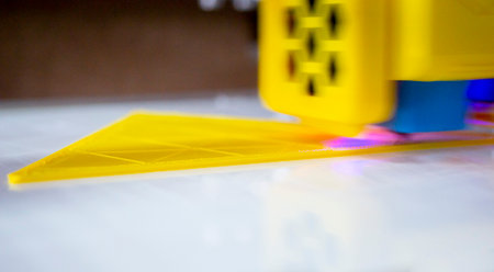 3D printer close up. A working 3D printer in process of printing object from molten plastic. 3D...