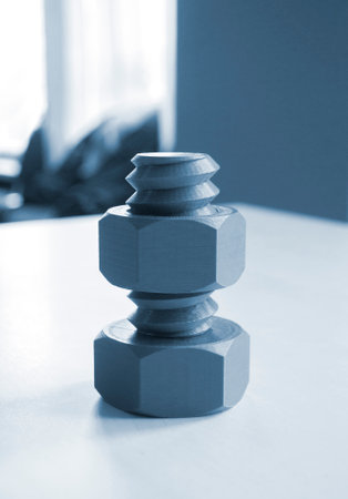 Object in form of washer and bolt of gray color printed on 3D printer. Three-dimensional model printed on 3D printer from molten plastic of red color. Concept 3D Printing. FDM 3D Printing technologyの写真素材