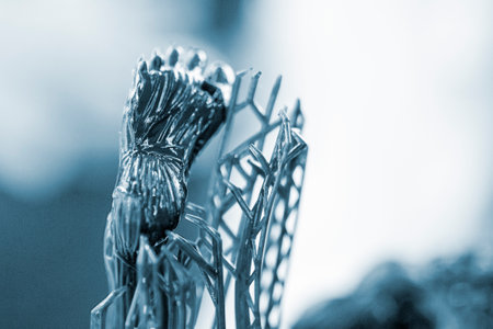 Model of leg printed on a 3D printer from black rubber, close-up. Part of an object created on a 3D printer from hardened rubber under the influence of ultraviolet light. SLA 3D printing technology.の写真素材