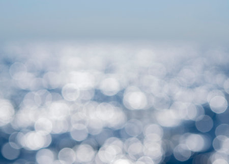 Sea. Abstract view of the blue sea with ripples on the water and white sun glare on a sunny summer day. Nature. Natural background. Blurred background. Concept summer vacation travel tourismの写真素材