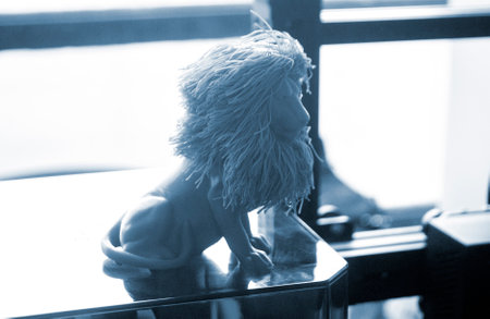 Art object blue lion printed on 3D printer. Abstract small toy model blue lion created on 3d...