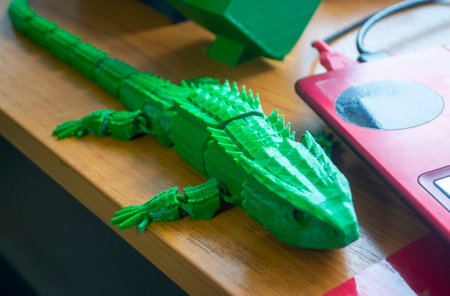 Object printed on 3D printer. Abstract toy green crocodile with many different detailed parts on table and created on 3d printer. Concept FDM 3D Printing. Additive modern new progressive technologyの写真素材