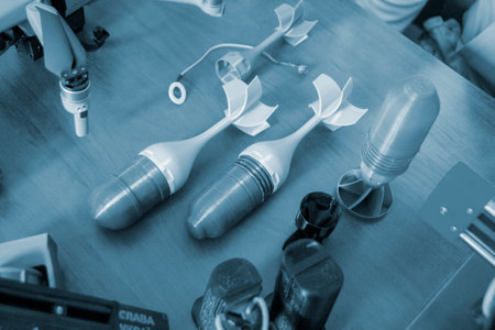Prototype model of rocket tip printed on 3D printer. Small models of tail fins, tail cone printed on 3D printer from molten plastic on table. New modern innovation printing technologyの写真素材
