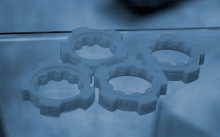 Many blue detail printed on 3D printer close-up. Part 3D printed from molten plastic. FDM...