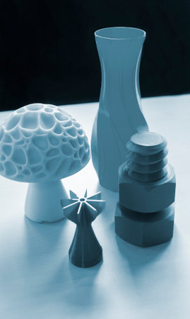 Several art objects printed on a 3D printer. Model blue vase, white mushroom, tip, gray washer and bolt created 3D printer from molten plastic. Additive progressive technologyの写真素材