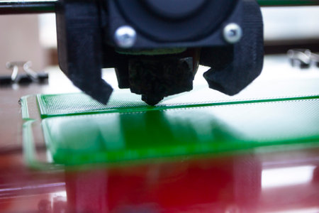 The process of printing on 3D printer. 3D printer creating model from molten plastic close-up. Molten plastic flowing of extruder and forming three-dimensional volumetric object. Additive technologiesの写真素材