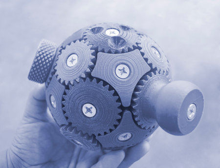 Person holding in his hand an object printed on 3D printer. Geometric model printed on 3D printer from molten plastic close-up. Shape created by 3D printer. FDM technology.の写真素材