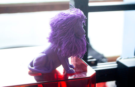 Art object blue lion printed on 3D printer. Abstract small toy model blue lion created on 3d printer. FDM 3D Printing technology.の写真素材