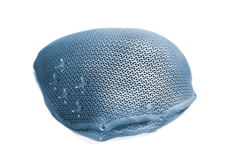 Titanium cranioplates for human skull isolated on white background. Individual cranioplasty printed on 3D printer from biointegrated titanium powder close-up. Biocompatible implants and endoprosthesesの写真素材