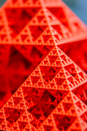 Art object printed on 3D printer from red melted plastic close-up. Model of pyramid created on 3D printer from plastic. 3D Printing technology. Additive progressive technology. New modern technologiesの写真素材