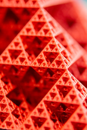 Art object printed on 3D printer from red melted plastic close-up. Model of pyramid created on 3D printer from plastic. 3D Printing technology. Additive progressive technology. New modern technologiesの写真素材