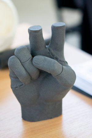 Hand printed on a 3D printer from polyamide powder. Three-dimensiona model of a human hand created on a 3D printer from plastic. Modern additive technologies. 3d printing technology. Manufacturingの写真素材