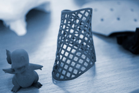 Objects printed on 3D printer from molten plastic powder. Different models printed on 3D printer from melted grey polyamide powder. Additive 3D printing Multi Jet Fusion MJF technologyの写真素材