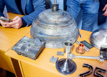 Objects printed with a 3D printer from a filament of molten metal on a table.