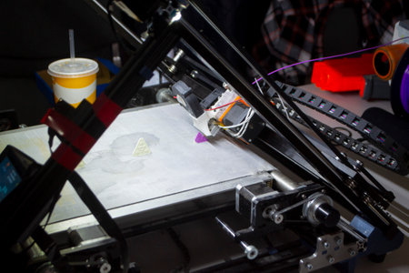 3D printer. 3D printer printing process close-up. 3D printer creating object from molten plastic. 3D...