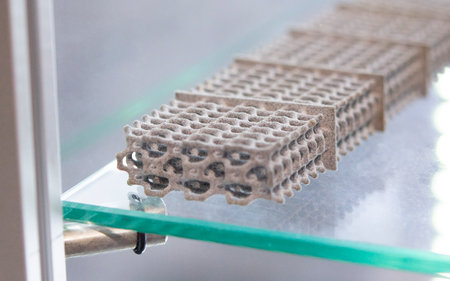 Model printed on 3D printer from grey polyamide powder close-up. Detailed prototype created on 3D...