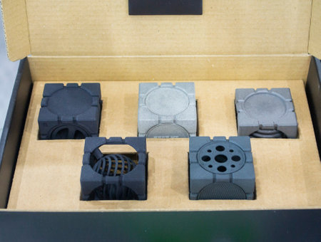 Different plastic models printed on 3D printer from powder. Objects created on 3D printer from...