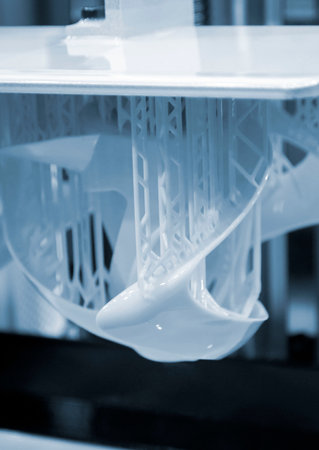 Printed models on 3D printer close-up. Objects printed on photopolymer sla 3D printer from liquid photopolymer resins on printing platform. Modern additive technology. 3D printer printing. Blue colorの写真素材