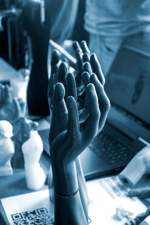 Art Object human hands printed on 3D printer. Model prototype of human hand printed on 3D printer from molten plastic on table. FDM 3D printing technology. New modern additive technologies. Blue colorの写真素材