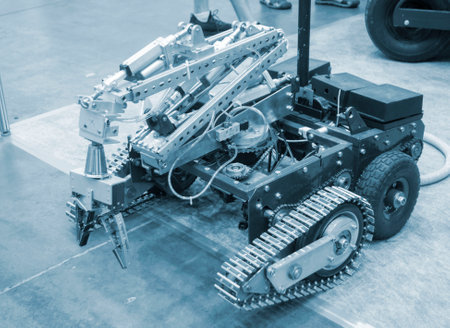 Small robot car unmanned with a crane and on tracks. Robotization robotics, new technology, radio...