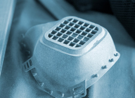 Filter mask respirator printed on a 3D printer from plastic. An object created on a 3D printer from sintered plastic powder. New modern additive technologies. 3D Printing technologyの写真素材