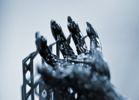 An object printed on a 3D printer from hardened rubber close-up. Model black color created on a 3D printer from hardened rubber under influence of ultraviolet light. SLA 3D printing. Stereolithographyの写真素材