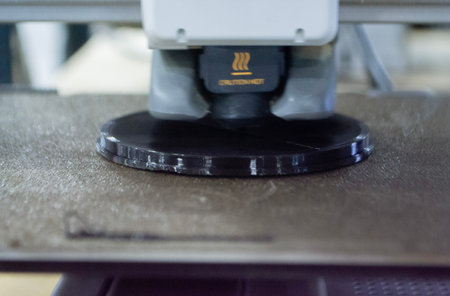 3D printer. 3D printer printing object close-up. 3D printer printing model black color. Working 3D...