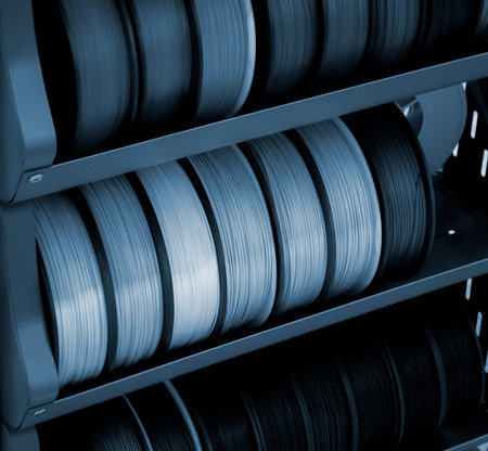 Spool of plastic wire for 3D printing. Different spool with plastic close-up. Component for 3d...