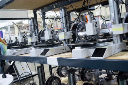 Many 3D printers printing object. 3D printers printing model from molten plastic. 3D printers...