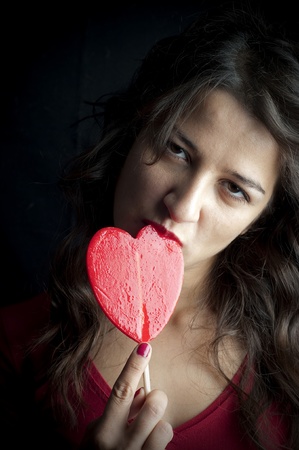 Portrait of girl with red lollipopの写真素材