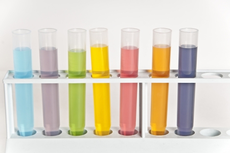 Glass test tubes filled with different coloured liquids.の写真素材