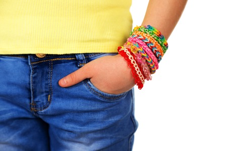 Hand in pocket teen girl with trendy handmade weaving bracelets on a white backgroundの写真素材