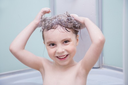 Cute little girl washing her hair