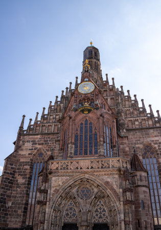 Gothic Frauenkirche in Nuremberg's Hauptmarkt, Germany, a stunning 14th-century Catholic church with restored inscriptions, historic artwork, and iconic medieval architecture.の写真素材