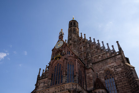Gothic Frauenkirche in Nuremberg's Hauptmarkt, Germany, a stunning 14th-century Catholic church with restored inscriptions, historic artwork, and iconic medieval architecture.の写真素材