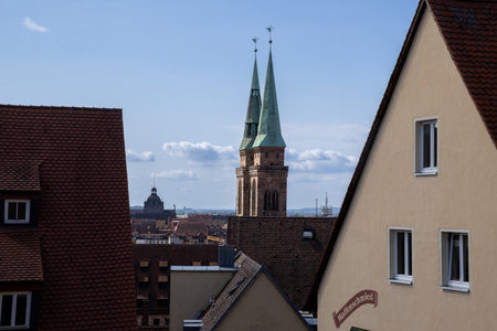 View from Nuremberg Castle, Germany, overlooking the city, with traditional timber-framed houses and the iconic towers of Sebalduskirche and St. Lorenzの写真素材