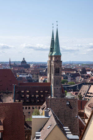 View from Nuremberg Castle, Germany, overlooking the city, with traditional timber-framed houses and the iconic towers of Sebalduskirche and St. Lorenzの写真素材