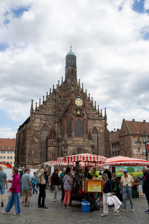 Gothic Frauenkirche in Nurembergâs Hauptmarkt, Germany, a stunning 14th-century Catholic church with restored inscriptions, historic artwork, and iconic medieval architecture.の写真素材