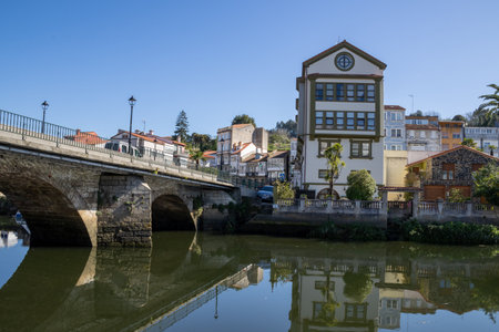Scenic view of Ponte Vella bridge over Mandeo River in Betanzos, Galicia, Spain, surrounded by lush...
