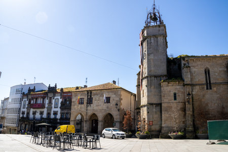 Historic Church of Santiago in Betanzos, Galicia, with Romanesque and Gothic elements under a clear...