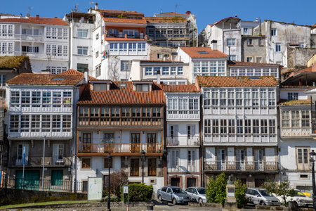 Scenic view from Praza a Enrique Ivntiga Eira Vella, Betanzos, Galicia, with riverside white homes and boats reflecting on the peaceful Mandeo River.の写真素材