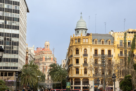 Crowds gather for the Mascletà, a thunderous firework show, safely watched from behind the protective cageの写真素材